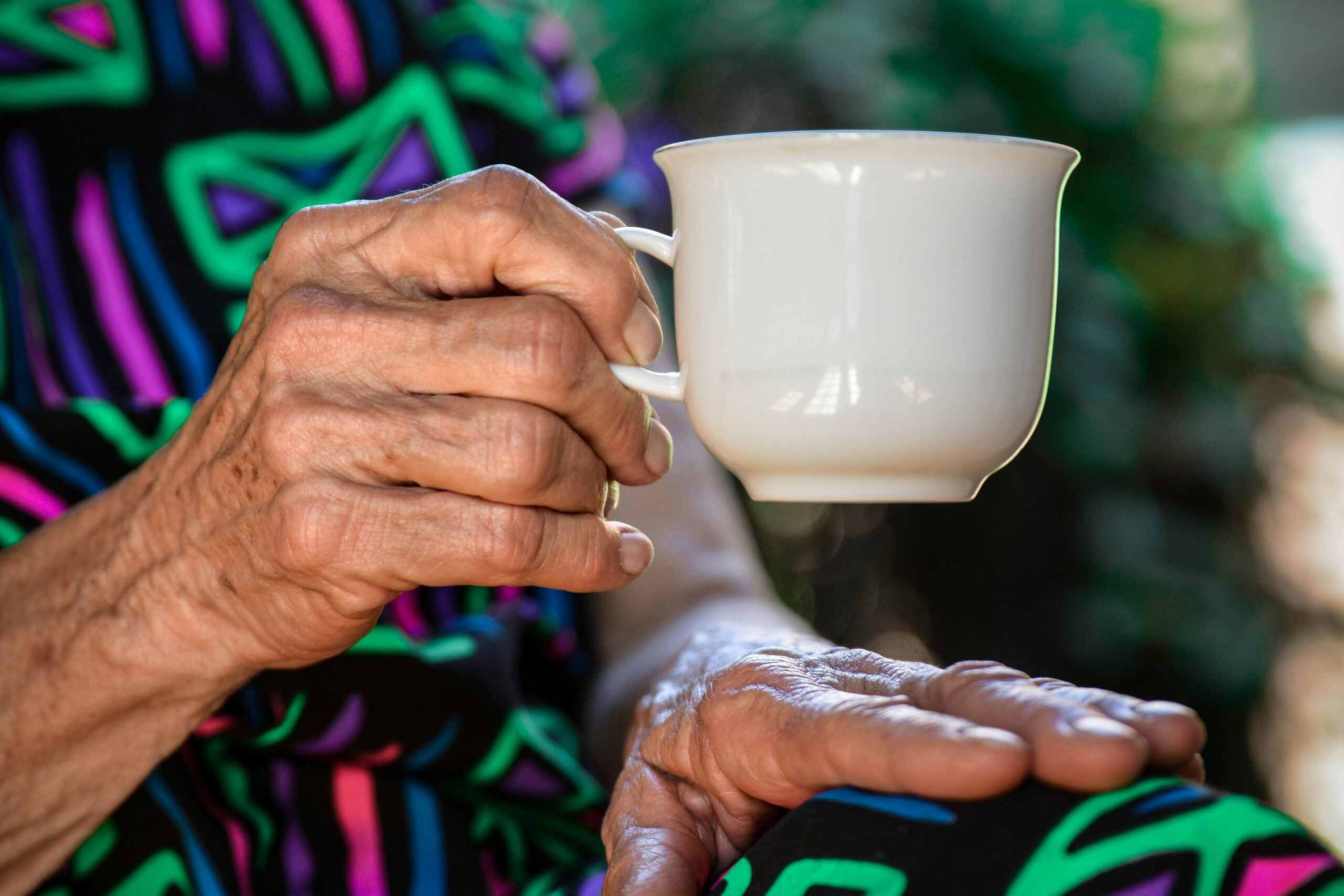 Hand holding a coffee cup.