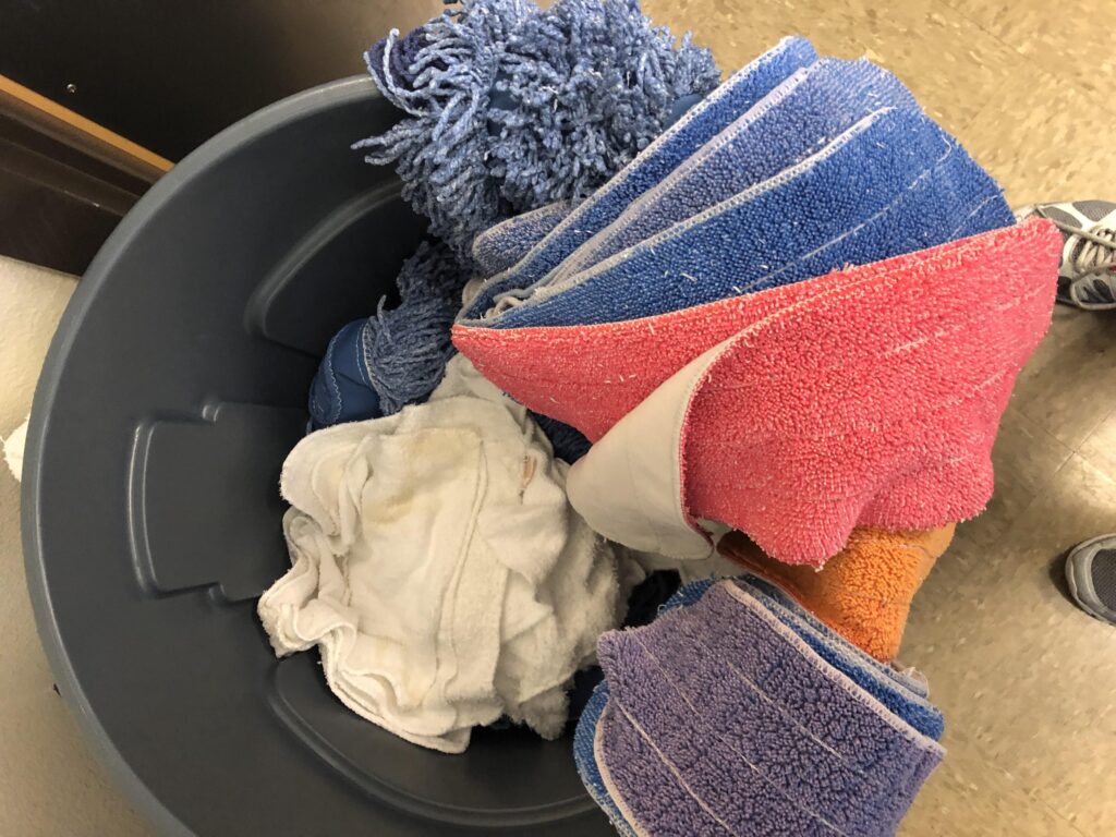 Bucket with cleaning supplies.
